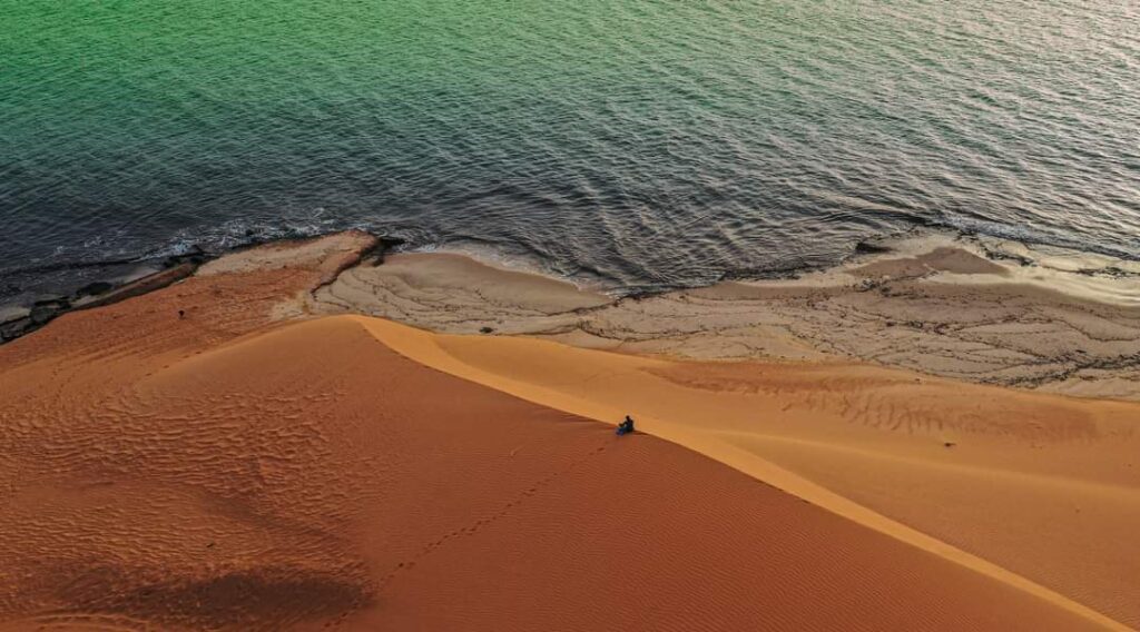 Pristine dunes edge up against clear waters of the Atlantic ocean in Banc d'Arguin National Park