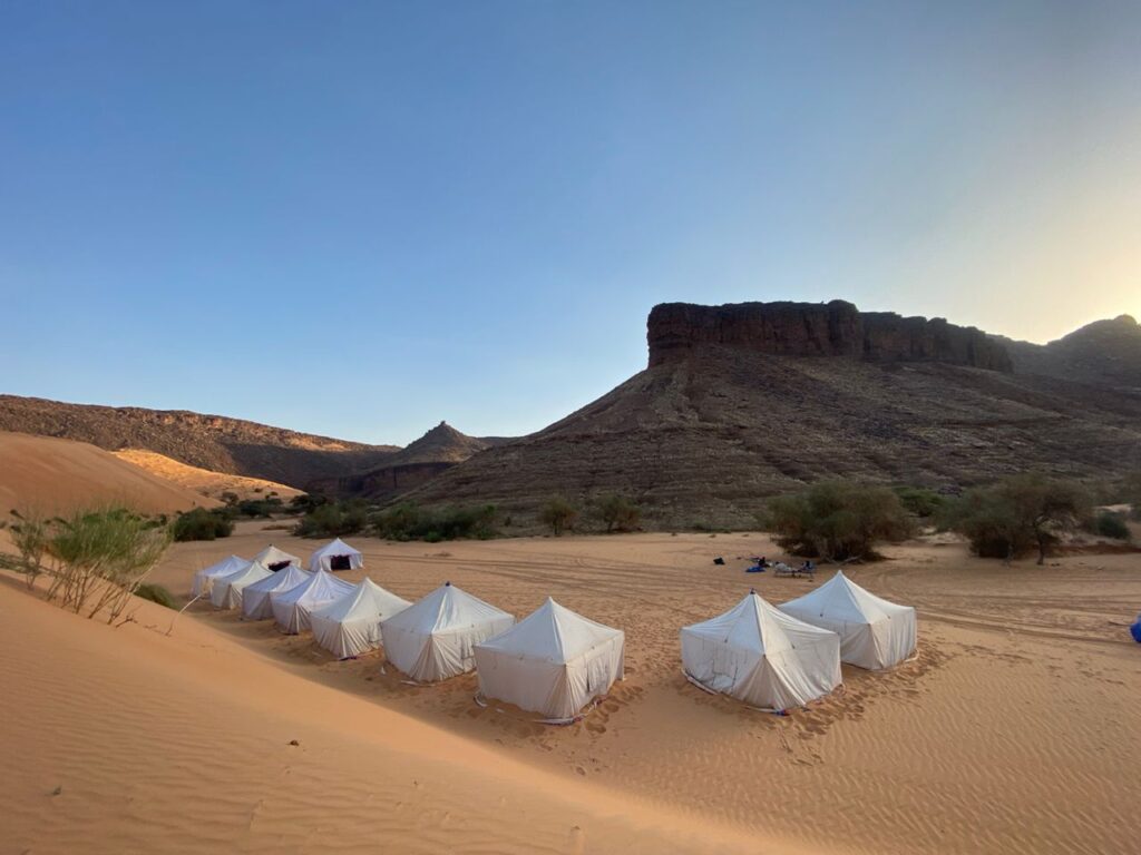 A luxury campsite is seen at the base of the Big Dunes of Azoueiga