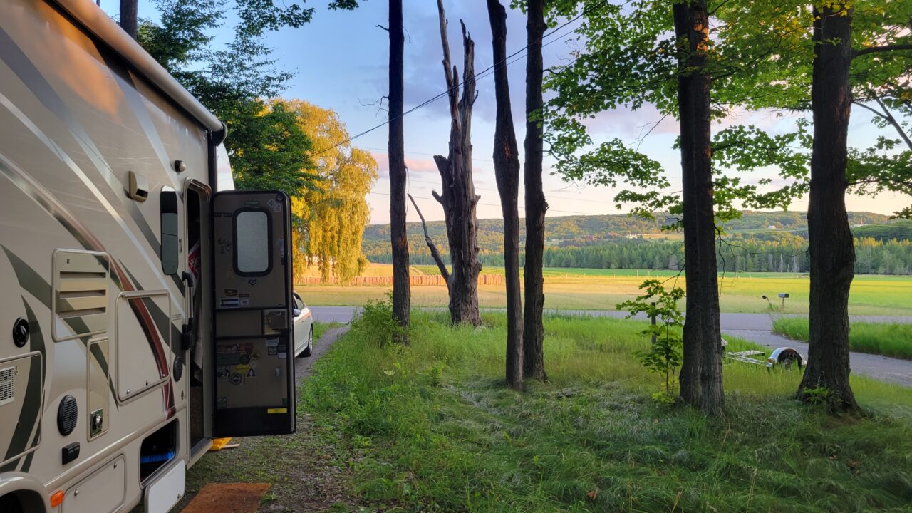 RV in Petoskey, MI looking over a field at golden hour.
