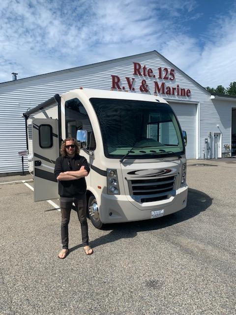 Rich, standing in front of his newly purchased RV.