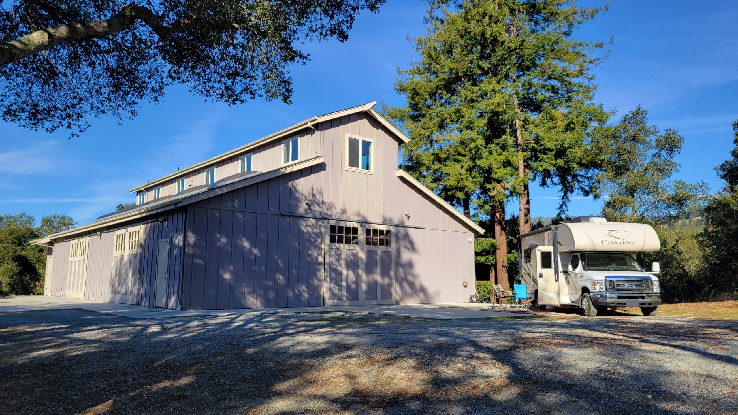 Thor Chateau parked outside of a large barn in the Santa Cruz Mountains
