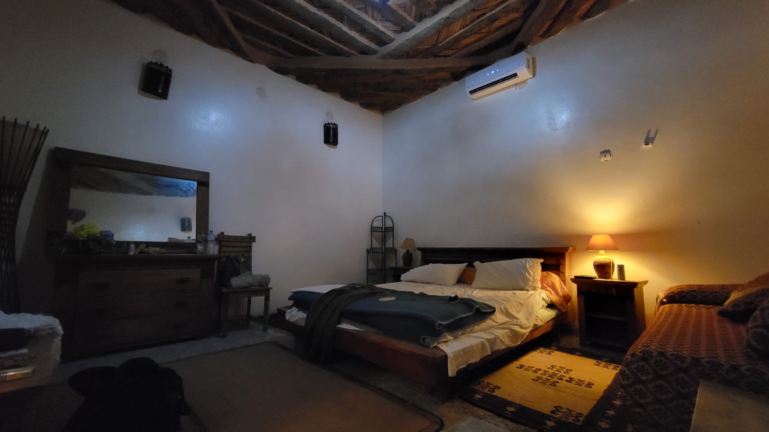 Large guest house room with a queen bed and air conditioning